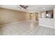 Open living area with ceramic tile floors open to the kitchen and dining areas at 1002 Chalcedony St, Kissimmee, FL 34744