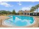 Resort-style pool with sun loungers, covered seating, and lush tropical landscaping at 1002 Chalcedony St, Kissimmee, FL 34744