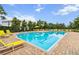 Community pool with clear water, surrounded by lounge chairs and landscaped areas at 1002 Chalcedony St, Kissimmee, FL 34744