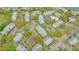 High-angle aerial of an apartment complex featuring tennis courts and a pool surrounded by trees at 1065 S Hiawassee Rd # 1425, Orlando, FL 32835