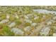 Expansive aerial shot of an apartment complex with tennis courts, pool, lake, and abundant parking at 1065 S Hiawassee Rd # 1425, Orlando, FL 32835