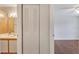View of a bathroom with white cabinets, a sink, and access to a bedroom with wood flooring at 1065 S Hiawassee Rd # 1425, Orlando, FL 32835