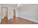 Bedroom showcasing wood floors, a ceiling fan, and access to a bathroom and closet at 1065 S Hiawassee Rd # 1425, Orlando, FL 32835