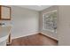 Bright dining area featuring wood floors, natural light from a large window, and neutral paint at 1065 S Hiawassee Rd # 1425, Orlando, FL 32835