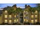 Apartment building featuring a balcony, stairs, and lush palm trees creating a welcoming tropical vibe at 1065 S Hiawassee Rd # 1425, Orlando, FL 32835