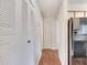 Hallway view featuring closets and laminate flooring, connecting kitchen at 1065 S Hiawassee Rd # 1425, Orlando, FL 32835