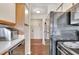 Efficient kitchen with stainless steel dishwasher, laminate countertops, and view of storage area at 1065 S Hiawassee Rd # 1425, Orlando, FL 32835