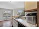 Well-maintained kitchen offering stainless steel sink, laminate countertops and wood-look floors at 1065 S Hiawassee Rd # 1425, Orlando, FL 32835