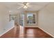 Spacious living area featuring hardwood floors, large windows, and a breakfast bar at 1065 S Hiawassee Rd # 1425, Orlando, FL 32835