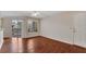 Hardwood floors throughout this sunlit living room with sliding doors leading to a balcony at 1065 S Hiawassee Rd # 1425, Orlando, FL 32835