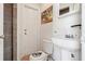 A well-lit half bathroom with a pedestal sink, and a decorative painting, conveniently located for guests at 115 Anzio Dr, Kissimmee, FL 34758
