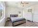 Bedroom showcasing wood-look floors, ceiling fan, white dresser and natural light at 115 Anzio Dr, Kissimmee, FL 34758