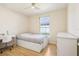 Bedroom featuring a full size bed, a desk and a view of the outside at 115 Anzio Dr, Kissimmee, FL 34758