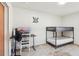 Bedroom with a bunk bed setup, desk, fan, and gaming setup at 115 Anzio Dr, Kissimmee, FL 34758
