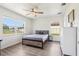 Bright bedroom with natural light showcasing wood-look flooring, ceiling fan, and comfortable bed at 115 Anzio Dr, Kissimmee, FL 34758