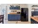 Kitchen featuring blue cabinets, tan countertops and stainless steel appliances at 115 Anzio Dr, Kissimmee, FL 34758