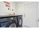 Laundry room featuring Samsung washer and dryer with black countertop at 115 Anzio Dr, Kissimmee, FL 34758