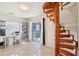 Living area featuring a spiral staircase, a desk and a sliding glass door to the patio at 115 Anzio Dr, Kissimmee, FL 34758