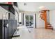 Living area with desk and spiral staircase leading upstairs and glass sliding door to the outside at 115 Anzio Dr, Kissimmee, FL 34758