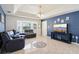 Bright and airy living room features a bay window, tile floors, and stylish furnishings at 115 Anzio Dr, Kissimmee, FL 34758