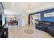 Open-concept living space with tile floors, a sliding barn door, and comfortable furnishings at 115 Anzio Dr, Kissimmee, FL 34758