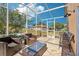 Screened patio with outdoor seating, offering a relaxing space to enjoy the weather and beautiful view at 115 Anzio Dr, Kissimmee, FL 34758