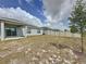 Fenced backyard featuring a covered patio with sliding glass doors and young trees at 119 Summerlin Loop, Haines City, FL 33844