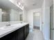 Bathroom featuring double sink vanity, tiled floors, glass shower door, and toilet at 119 Summerlin Loop, Haines City, FL 33844
