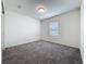 A cozy bedroom has soft carpet and a window for natural light at 119 Summerlin Loop, Haines City, FL 33844