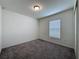 Carpeted bedroom with neutral walls, featuring a single window and a door to the closet at 119 Summerlin Loop, Haines City, FL 33844