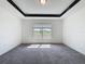 A bright bedroom features neutral carpeting and a large window with views of the exterior at 119 Summerlin Loop, Haines City, FL 33844