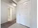 Entryway with tile flooring leading to carpeted hallway and bathroom with shower and tub at 119 Summerlin Loop, Haines City, FL 33844