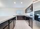 Updated kitchen featuring stainless steel appliances, a large island, and modern finishes at 119 Summerlin Loop, Haines City, FL 33844
