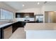 Modern kitchen featuring stainless steel appliances, dark cabinetry, and light countertops at 119 Summerlin Loop, Haines City, FL 33844