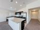 Bright, open-concept kitchen with stainless steel appliances and a spacious island at 119 Summerlin Loop, Haines City, FL 33844
