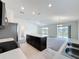 Open concept kitchen featuring stainless steel appliances, dark cabinets, an island, and views to the living space at 119 Summerlin Loop, Haines City, FL 33844