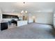 Spacious living room and kitchen area with dark cabinets, stainless appliances, and plenty of room at 119 Summerlin Loop, Haines City, FL 33844