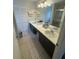 Spacious bathroom with double sinks, ample counter space, and neutral tiling for a clean look at 1211 Carey Glen Cir, Orlando, FL 32824