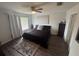 A cozy bedroom with a ceiling fan, window, and wood-like floors, offering a relaxing space at 1211 Carey Glen Cir, Orlando, FL 32824