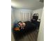 A bedroom with wood-like floors, a black bed set, and a closet, offering a private retreat at 1211 Carey Glen Cir, Orlando, FL 32824
