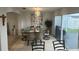 Elegant dining room with stylish lighting, neutral paint, and access to the backyard at 1211 Carey Glen Cir, Orlando, FL 32824
