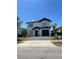 Charming two-story home with a well-maintained front yard and a paved driveway leading to an attached garage at 1211 Carey Glen Cir, Orlando, FL 32824