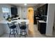 Kitchen featuring dark cabinetry, white countertops, stainless appliances, and breakfast bar at 1211 Carey Glen Cir, Orlando, FL 32824