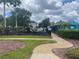 Community playground featuring slides and climbing structures within a fenced area at 1211 Carey Glen Cir, Orlando, FL 32824