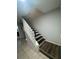 A well-lit staircase with dark wood treads and white risers, ascending to the upper level at 1211 Carey Glen Cir, Orlando, FL 32824