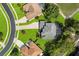 This aerial shot captures the home's layout and proximity to lush greenery and a tranquil pond at 13044 Lakeshore Grove Dr, Winter Garden, FL 34787