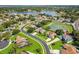 A neighborhood aerial view featuring a pond, mature landscaping, and a well-maintained community at 13044 Lakeshore Grove Dr, Winter Garden, FL 34787