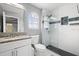 Bathroom featuring a granite vanity, glass shower, and modern fixtures at 13044 Lakeshore Grove Dr, Winter Garden, FL 34787