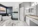 Modern bathroom featuring a soaking tub, glass enclosed shower, and marble flooring at 13044 Lakeshore Grove Dr, Winter Garden, FL 34787