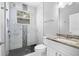 Bathroom featuring white marble tiled shower, toilet, and white vanity with granite countertop at 13044 Lakeshore Grove Dr, Winter Garden, FL 34787